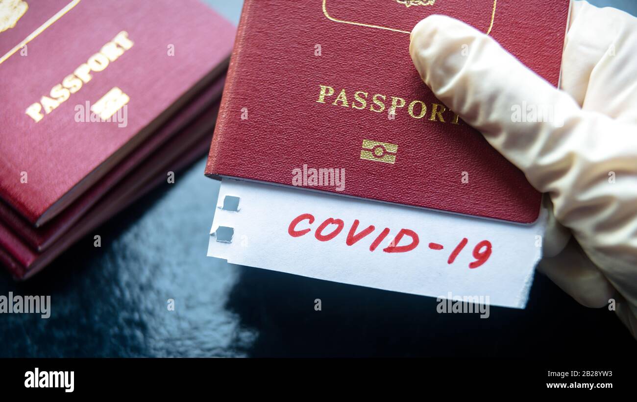 Coronavirus and travel concept. Note COVID-19 coronavirus and passport. Novel corona virus outbreak. Spread of epidemic from China. Border control and Stock Photo