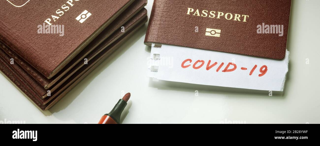 Coronavirus and travel concept. Note COVID-19 coronavirus and passport. Novel corona virus outbreak. Spread of epidemic from China. Border control and Stock Photo