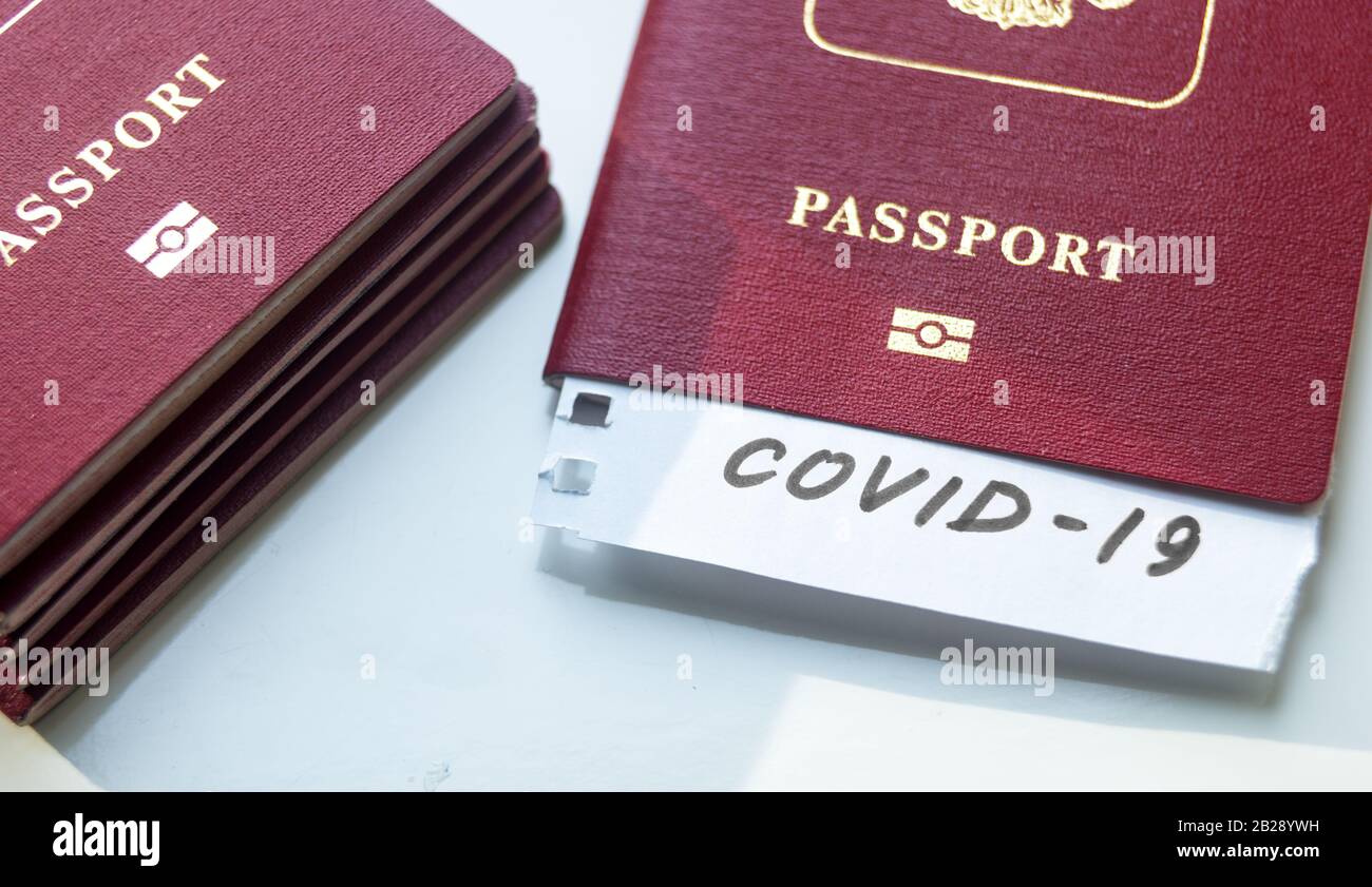 Coronavirus and travel concept. Note COVID-19 coronavirus and passport. Novel corona virus outbreak. Spread of epidemic from China. Border control and Stock Photo