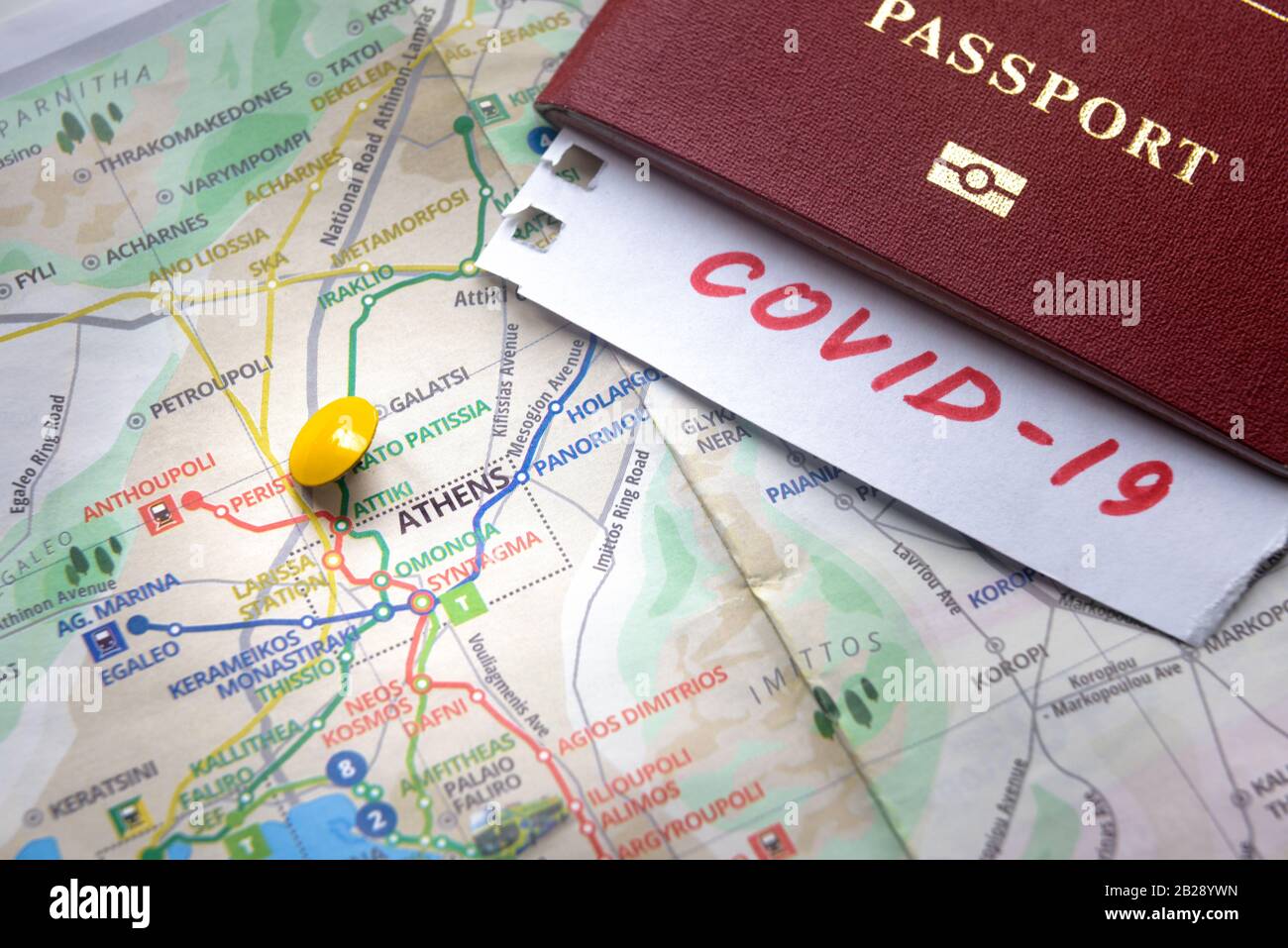 Coronavirus epidemic and travel restrictions in Greece concept. The note COVID-19 and passport on map with Athens. Novel corona virus outbreak. Border Stock Photo