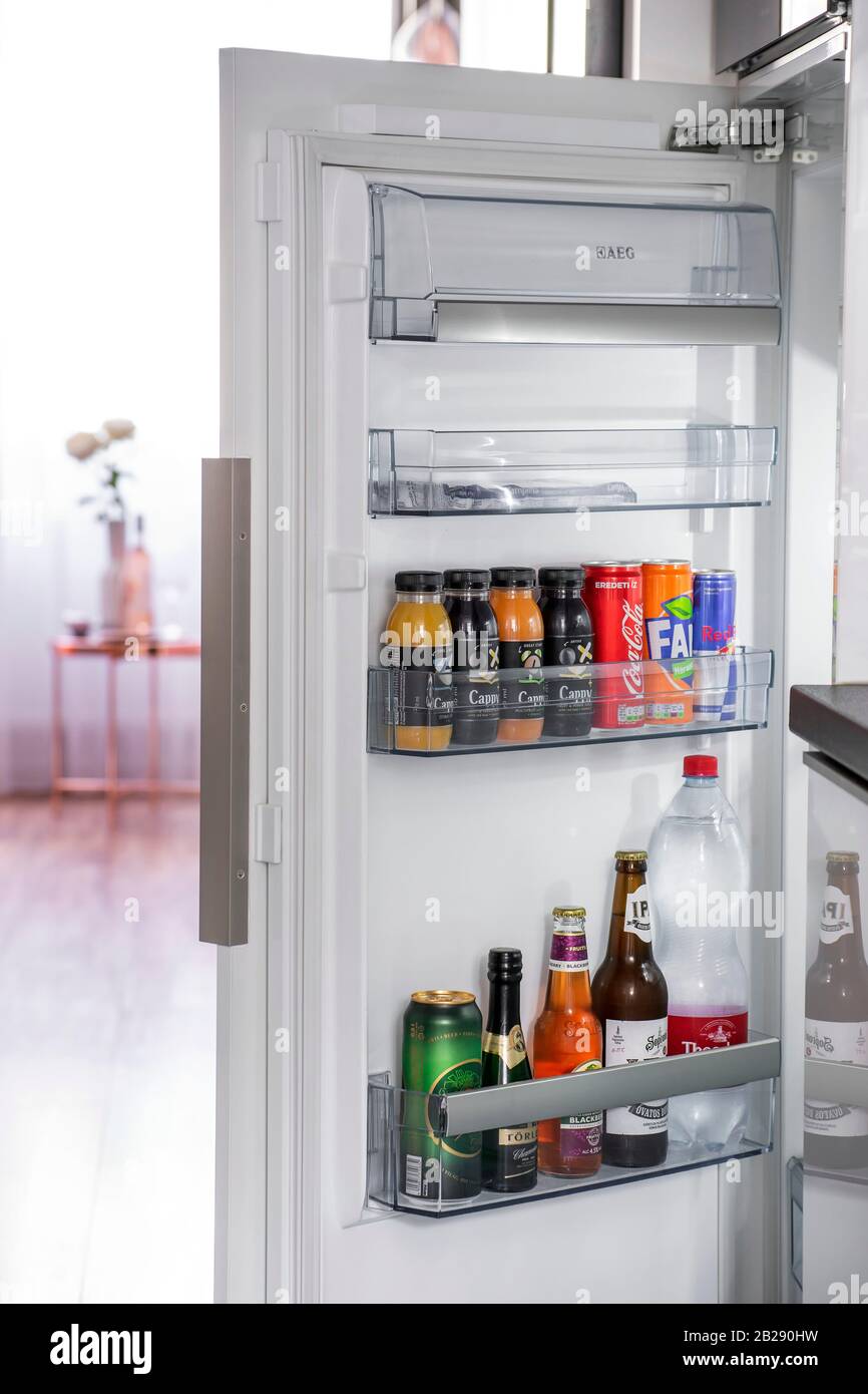 Budapest, Hungary - April 18, 2019: Door of opened fridge stacked with alcoholic and non-alcoholic drinks. Stock Photo