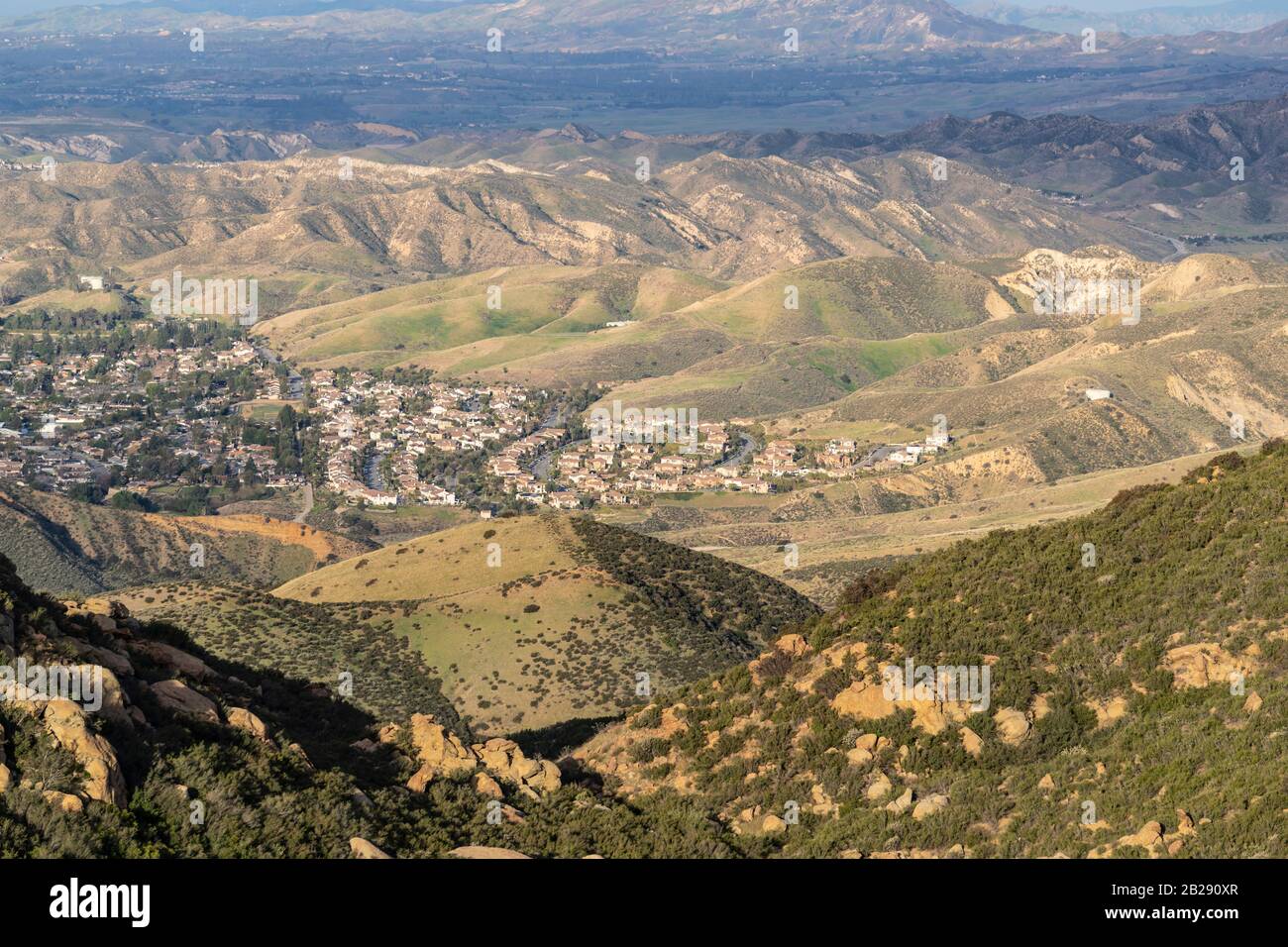 Mountaintop view of suburban streets and homes spreading towards open hillsides in Simi Valley