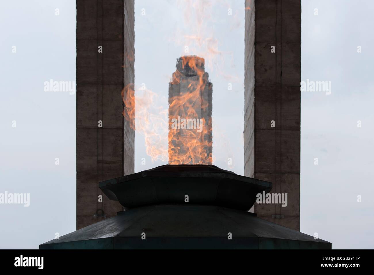 Tower of the National Flag Memorial seen through the fire of the votive flame in Rosario, Argentina Stock Photo