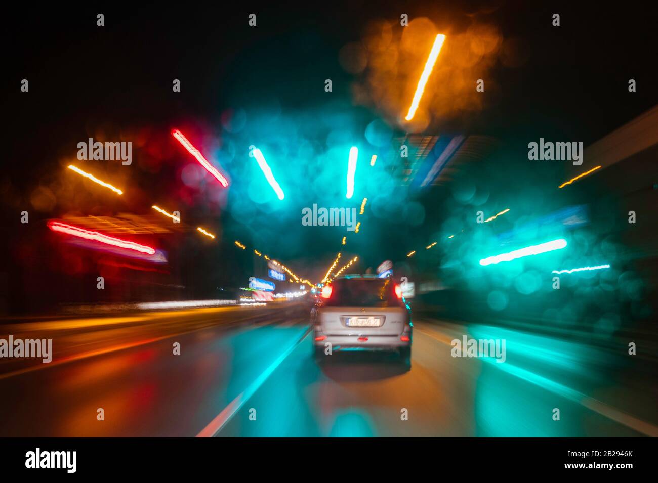 City colorful night lights perspective blurred by high speed of the car. A streak of light, trails. Stock Photo