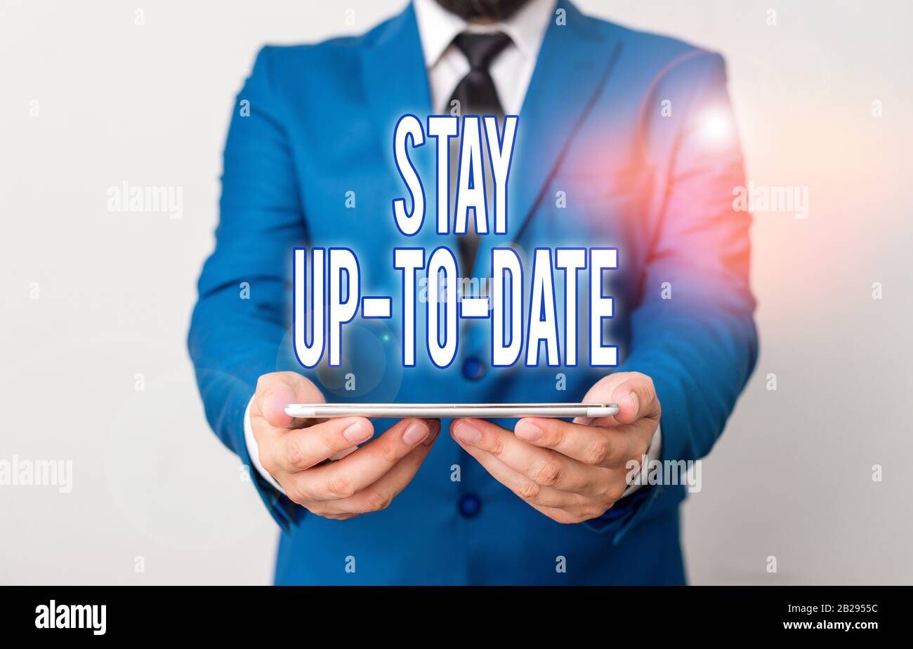 Word writing text Stay Up To Date. Business photo showcasing knows all the most recent news and changes in a situation Businessman in blue suite with Stock Photo