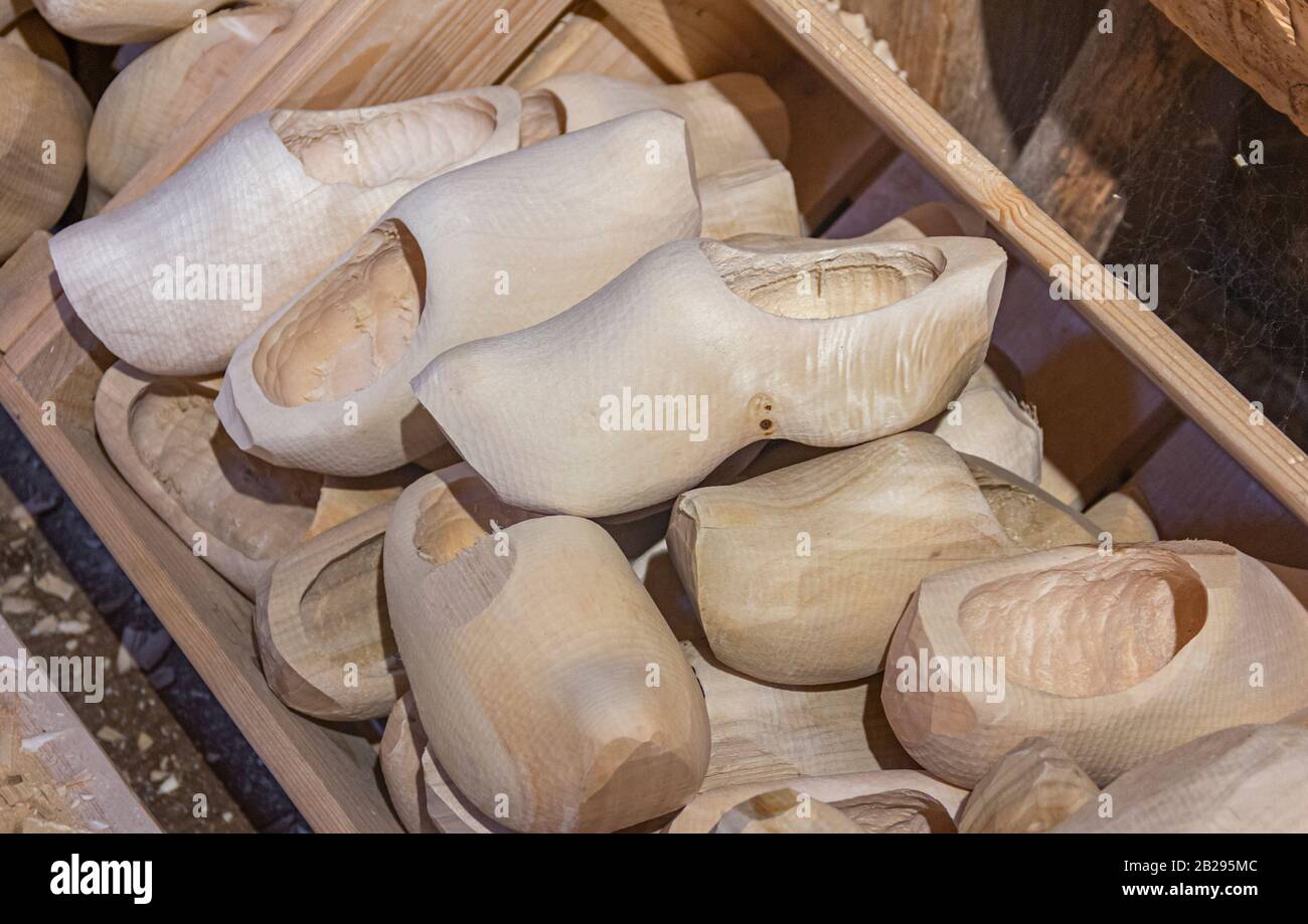 Manufacturing wooden shoes Klompen (clogs) in Holland. National traditional Dutch wooden shoes. Clog and Klomp Workshop. machine and part blanks. Stock Photo