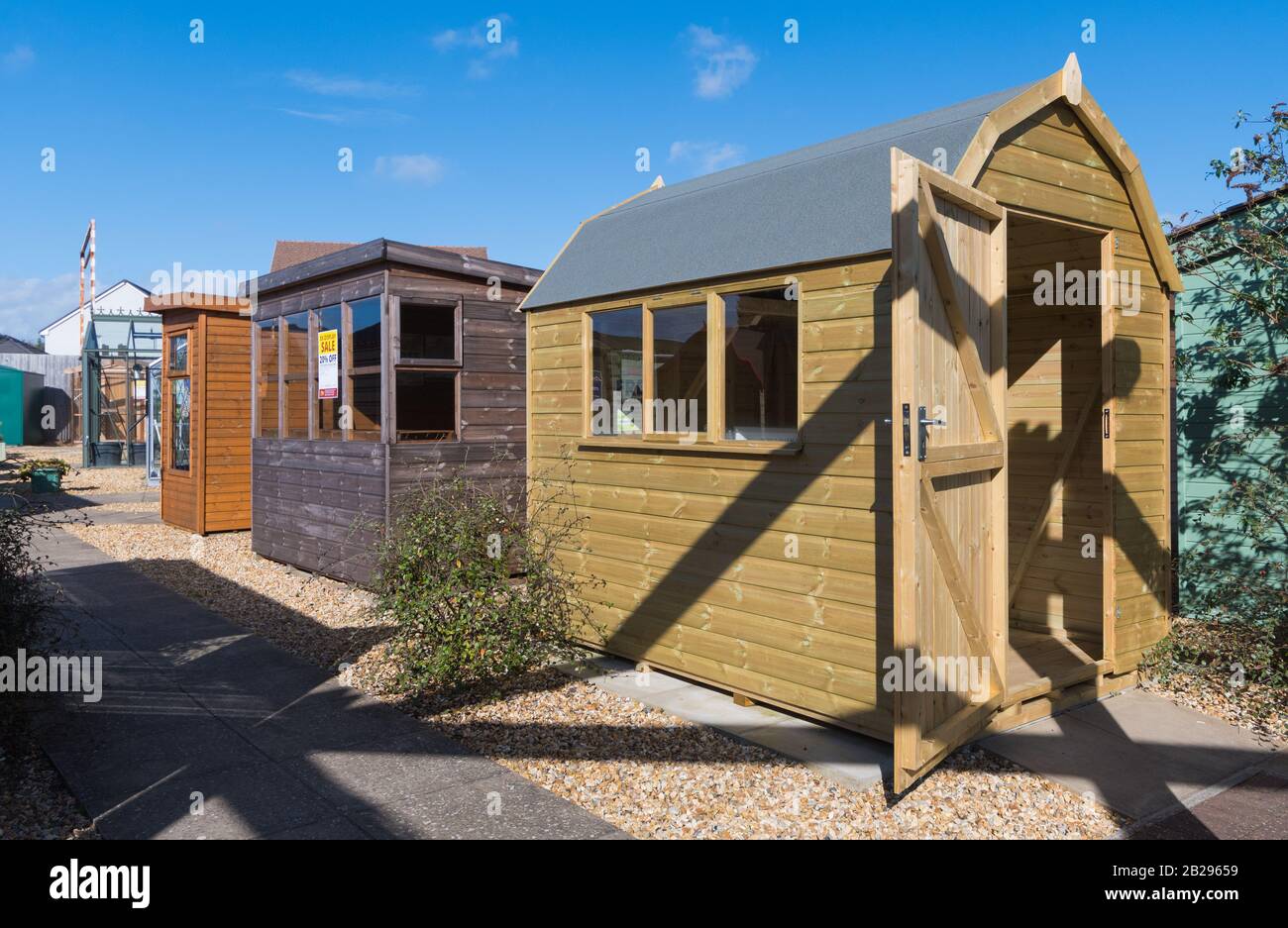 Display of wooden garden sheds for sale at a British garden centre in England, UK. Stock Photo