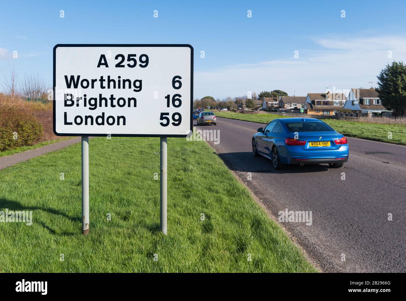 A259 main A road at Roundstone Bypass Road in Angmering, West Sussex, England, UK. Road sign to London. Roundstone by-pass road. Stock Photo