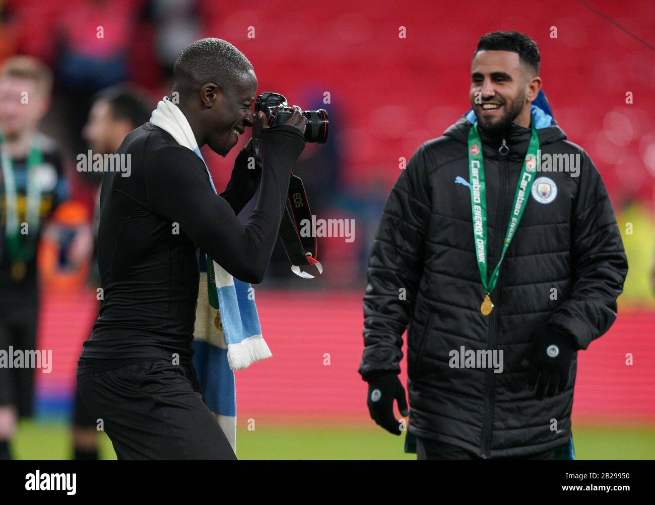Birmingham, UK. 01st Mar, 2020. Benjamin Mendy of Man City takes the club photographers camera to take photos of teammates during the Carabao Cup Final match between Aston Villa and Manchester City at Wembley Stadium, London, England on 1 March 2020. Photo by Andy Rowland. Credit: PRiME Media Images/Alamy Live News Stock Photo