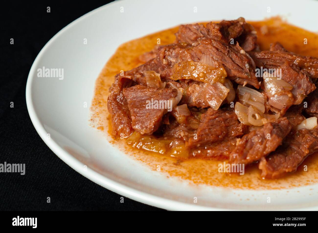 Greek dish Stifado, made with lamb and served with Greek salad. Can