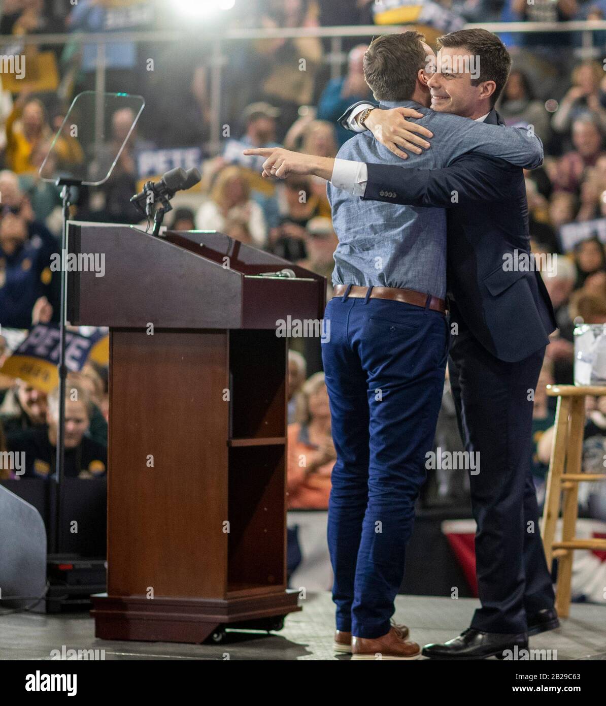 Raleigh, North Carolina, USA. 29th Feb 2020. Pete Buttigieg acknowledges a well-wisher as he is hugged by husband Chasten Buttigieg, during a campaign rally in Raleigh, N.C., Saturday, Feb. 29, 2020. Buttigieg, who finished in fourth place this evening in neighboring South Carolina, is campaigning in North Carolina and other states in advance of the big Super Tuesday matchups on March 3, which might serve to narrow the democratic field immensely. Credit: Sipa USA/Alamy Live News Stock Photo