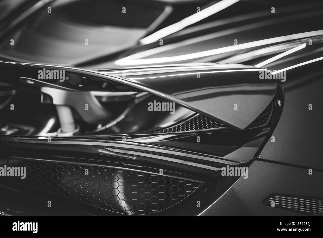 Side view of the spoiler and stop light of a sports car in black and white Stock Photo