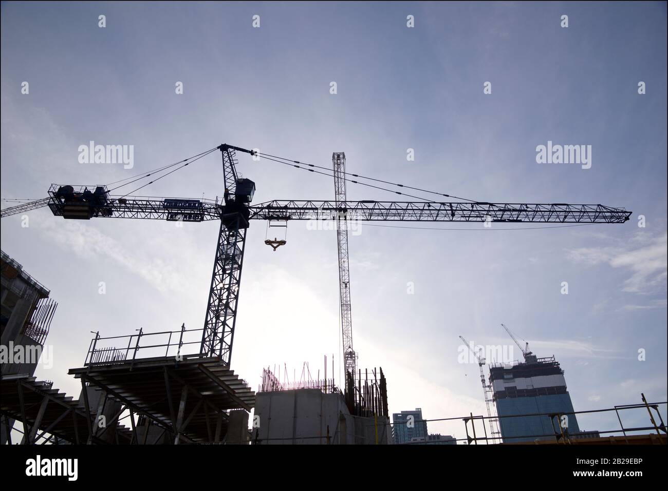Cranes over construction site with the blue sky background Stock Photo