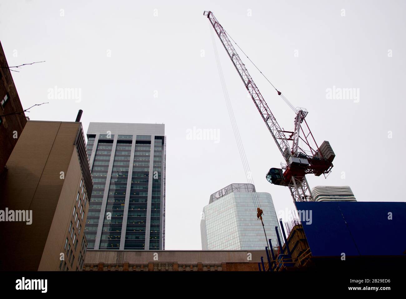 Cranes over a construction site in Toronto downtown Stock Photo