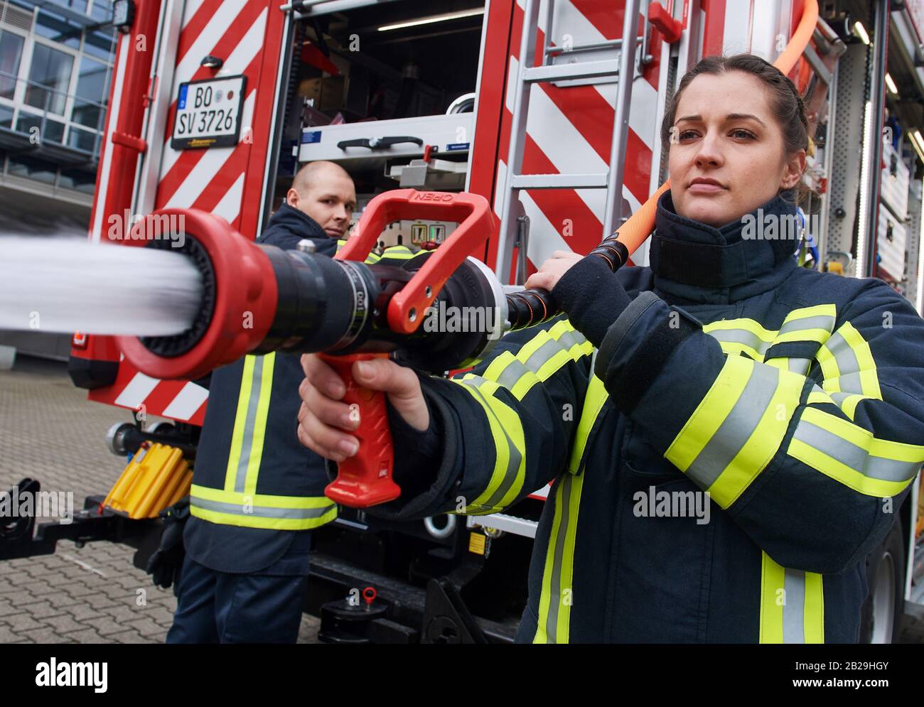 Bochum, Germany. 19th Feb, 2020. Firefighter Jasmin (29) stands next to a colleague in front of a fire engine and operates the water pump. Women are the exception in the professional fire brigade in Germany. According to the latest figures from the end of 2017, women account for only 1.41 percent of all members of the professional fire brigade. The 29-year-old is part of a team that will be the focus of the new WDR docutainment season 'Feuer & Flamme' starting on 23 March. Credit: Bernd Thissen/dpa/Alamy Live News Stock Photo