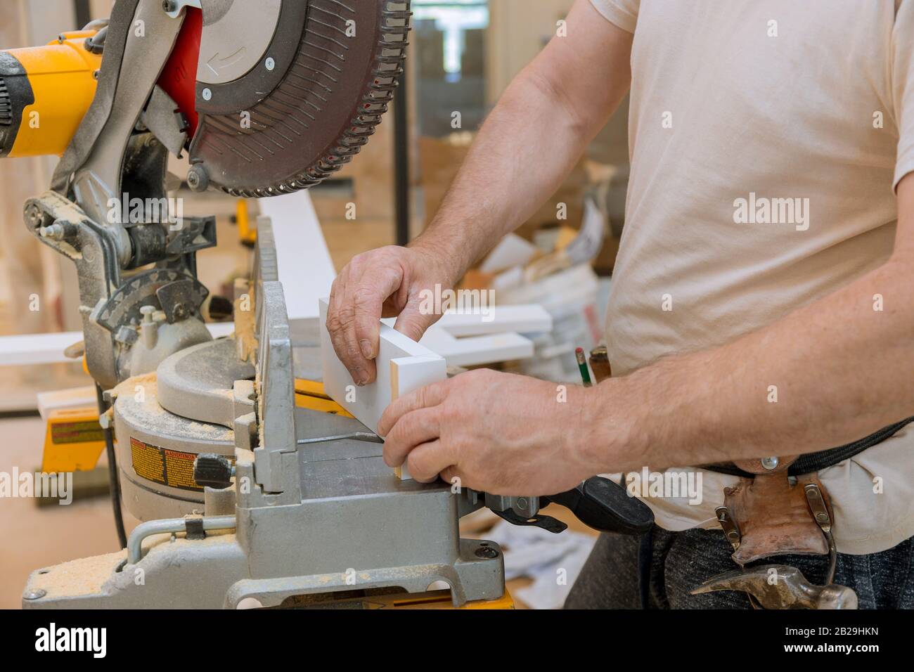 Carpenter working cutting base molding by circular saw Stock Photo Alamy