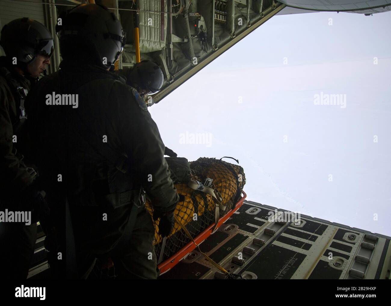 Loadmasters from the 211th Rescue Squadron push out a sled with an arctic sustainment package out of a HC-130J Combat King II at Deadhorse, Alaska, in support of exercise Arctic Eagle 2020, Feb. 25, 2020. The Alaska National Guard is hosting exercise Arctic Eagle 2020, a joint-training exercise, Feb. 20 to March 6, 2020 throughout Alaska, including Joint Base Elmendorf-Richardson, Eielson Air Force Base, Fort Wainwright, the Yukon-Kuskokwim Delta and as far north as Teshekpuk Lake. As a homeland security and emergency response exercise, Arctic Eagle 20 is designed to increase the National Guar Stock Photo