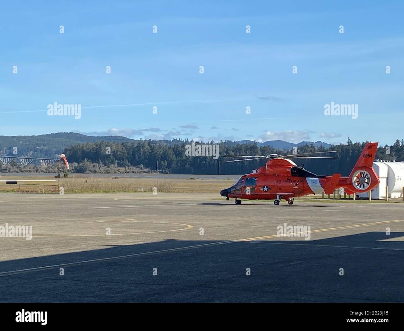 A Coast Guard MH-65 Dolphin helicopter sits on the tarmac at Sector North Bend, in North Bend, Oregon, Feb. 26, 2020. Sector North Bend operates five Dolphin helicopters to protect southern Oregon. (U.S. Coast Guard photo by Lt. Ryan Brown) Stock Photo