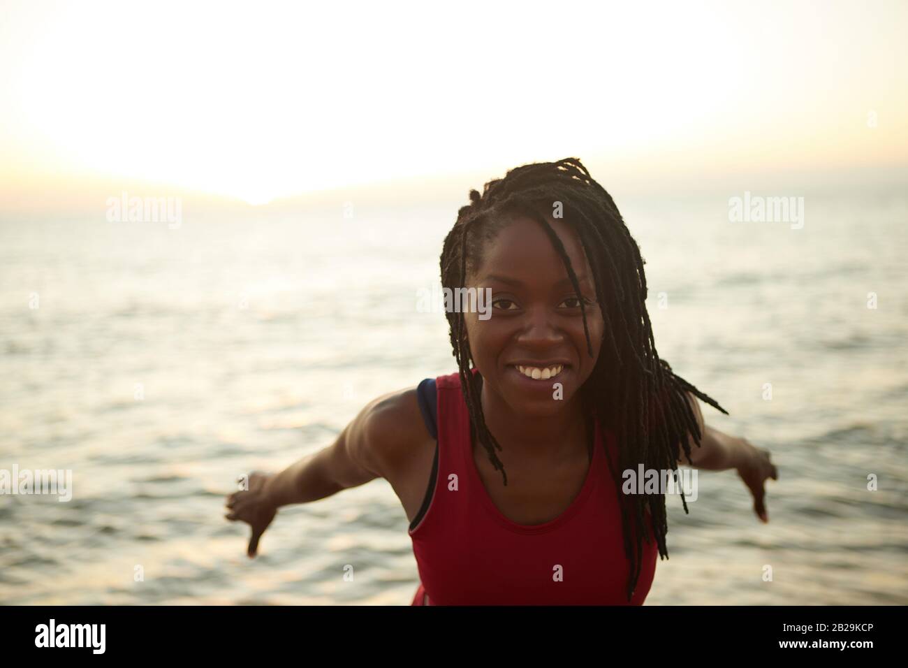 Portrait of happy young Black woman with white toothy smile standing on ...