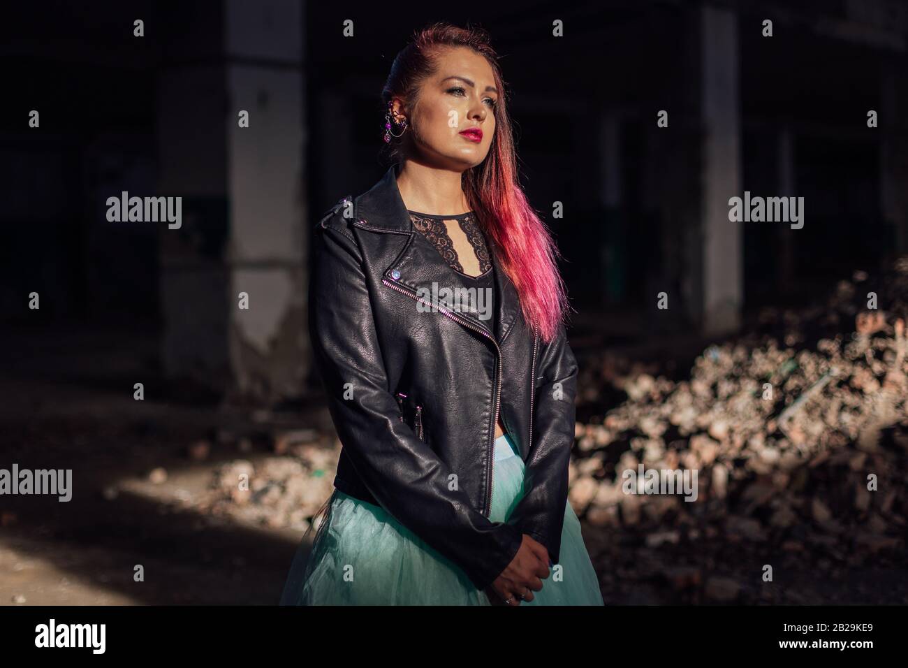 Pink Buildin Collapse Portrait of a young girl with pink hair standing next to the bricks in ...