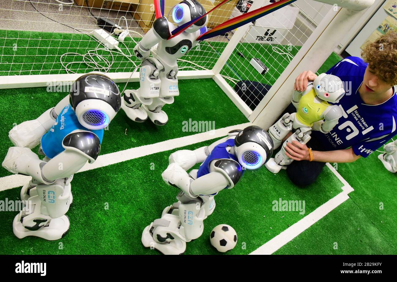 20 February 2020, Saxony, Leipzig: In the robot laboratory of the Nao-Team  of the University of Applied Sciences (HTWK) student Felix Loos checks the  test game of the robot soccer players. The