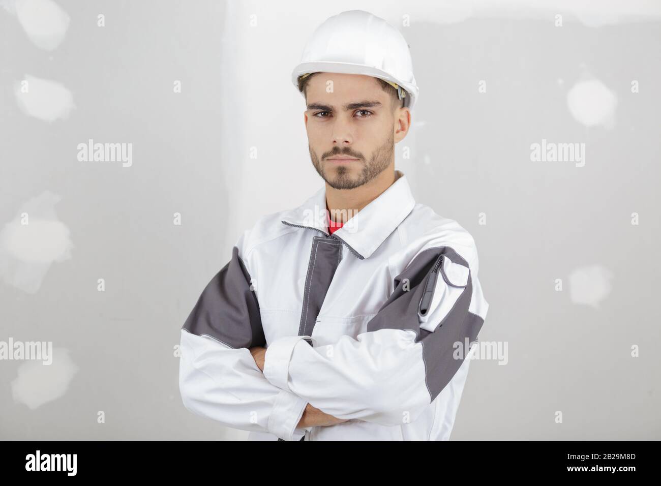 smart pensive builder thinking about something indoors Stock Photo
