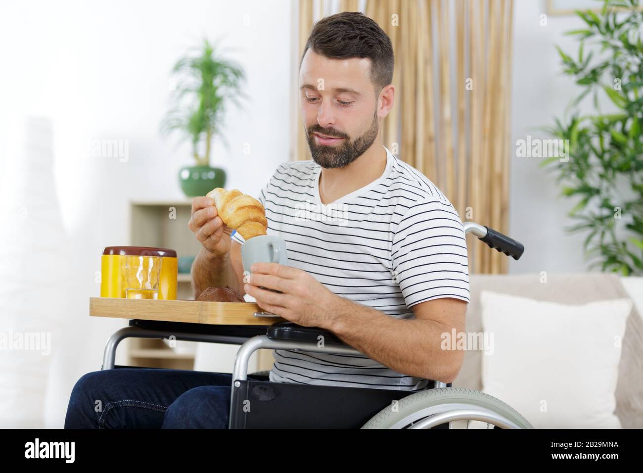 handsome man in wheelchair having a break Stock Photo