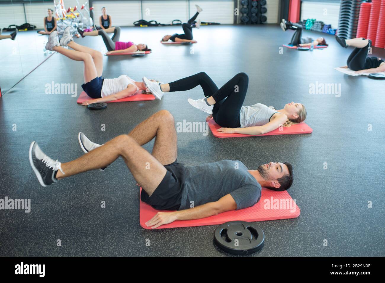 exercise class doing cycling action on the floor Stock Photo Alamy