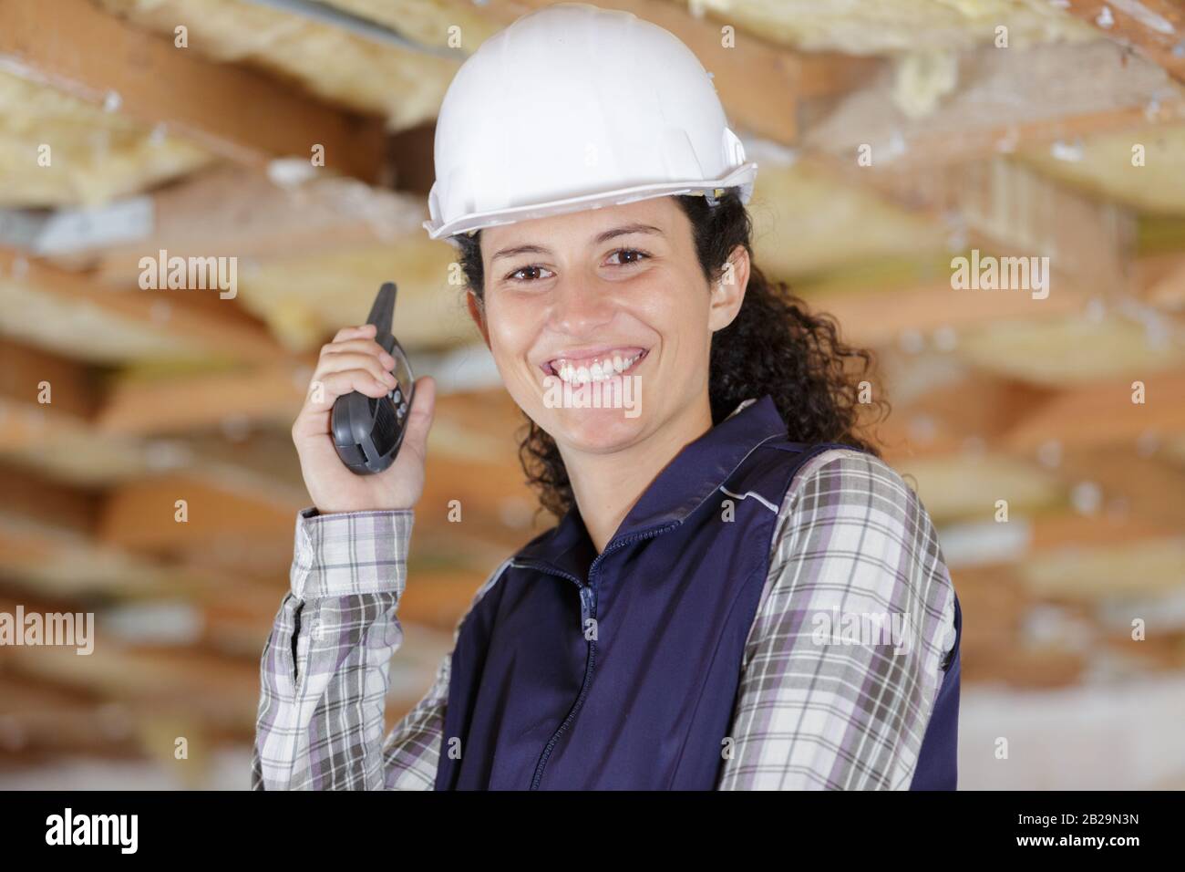 female construction worker using walkie talkie Stock Photo