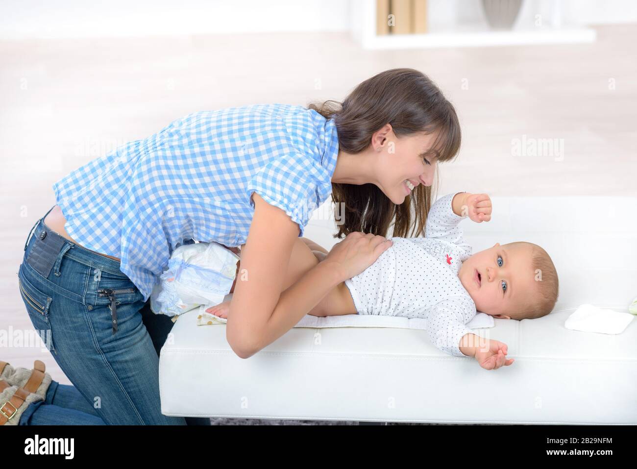 a mother changing baby child Stock Photo Alamy