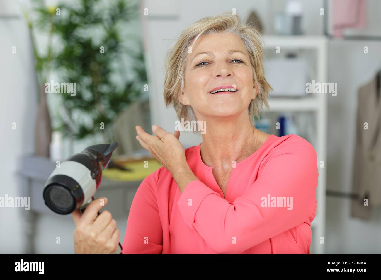Mature woman blow dryer hi-res stock photography and images - Alamy