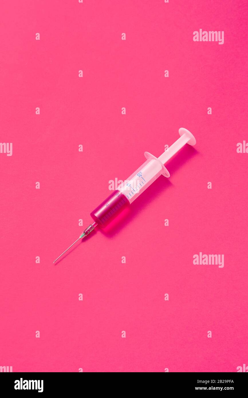 Disposable syringes of hot pink vaccine with soft shadows Stock Photo ...