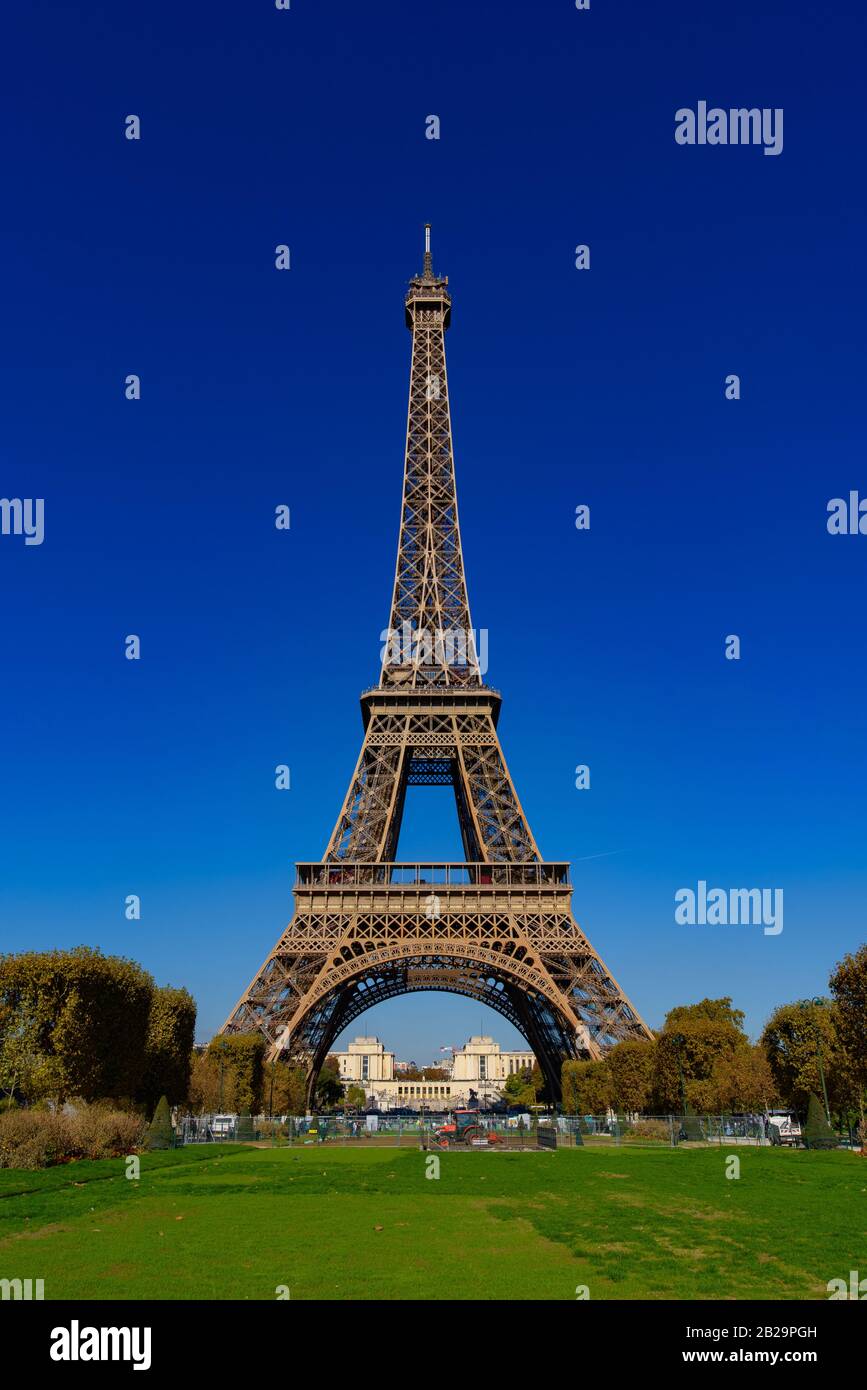Eiffel Tower with Champs de Mars and sunny blue sky in Paris, France Stock Photo
