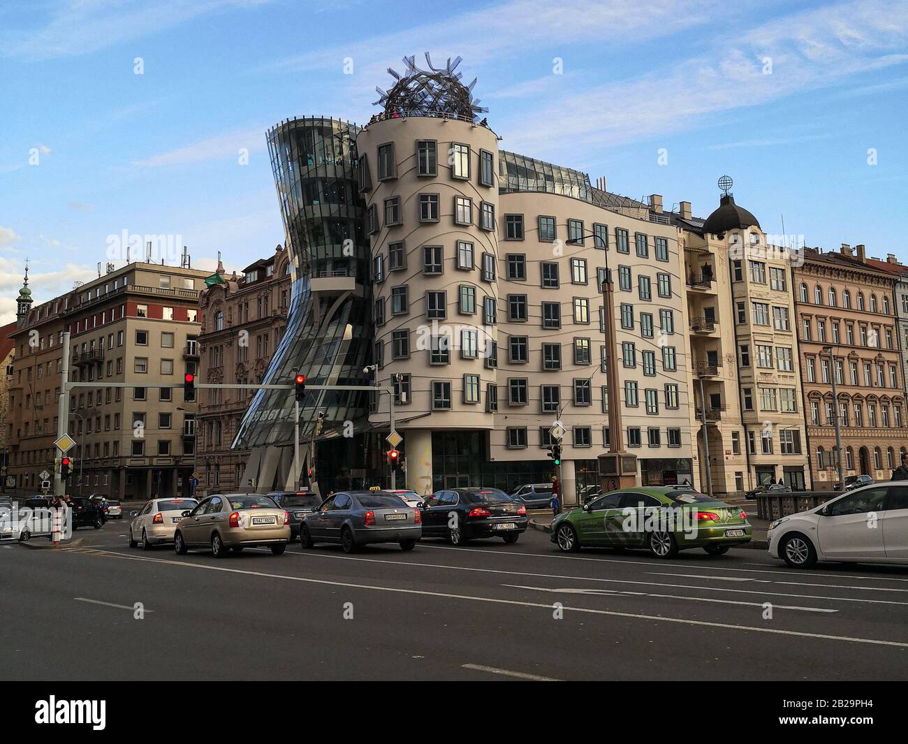 Famous dancing house building architecture in prague with car traffic transport Stock Photo