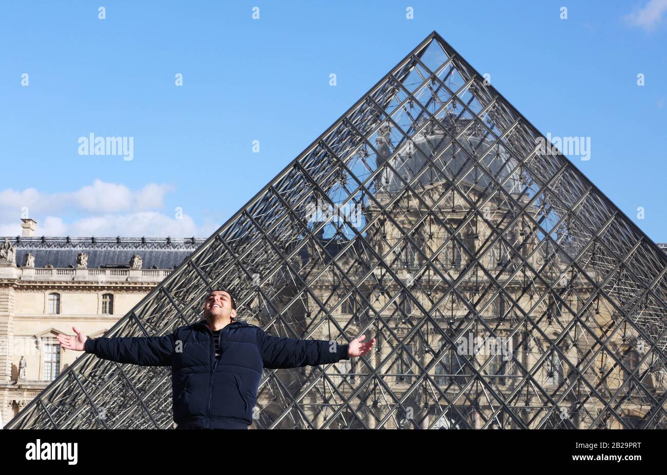 Paris. 11th Mar, 2019. File photo taken on March 11, 2019 shows a tourist posing for a photo in front of the Louvre Museum in Paris, France. The Louvre Museum was shut down on March 1 due to the spreading coronavirus epidemic. Credit: Gao Jing/Xinhua/Alamy Live News Stock Photo