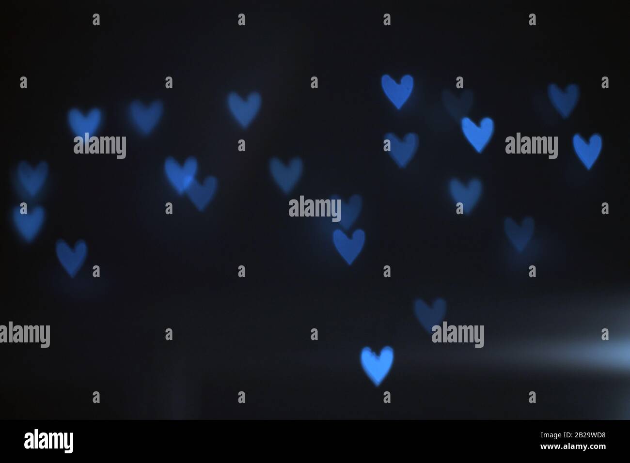 Heart-shaped light spots in the night on a dark background glow, shine.  Garland. Blurred Stock Photo - Alamy
