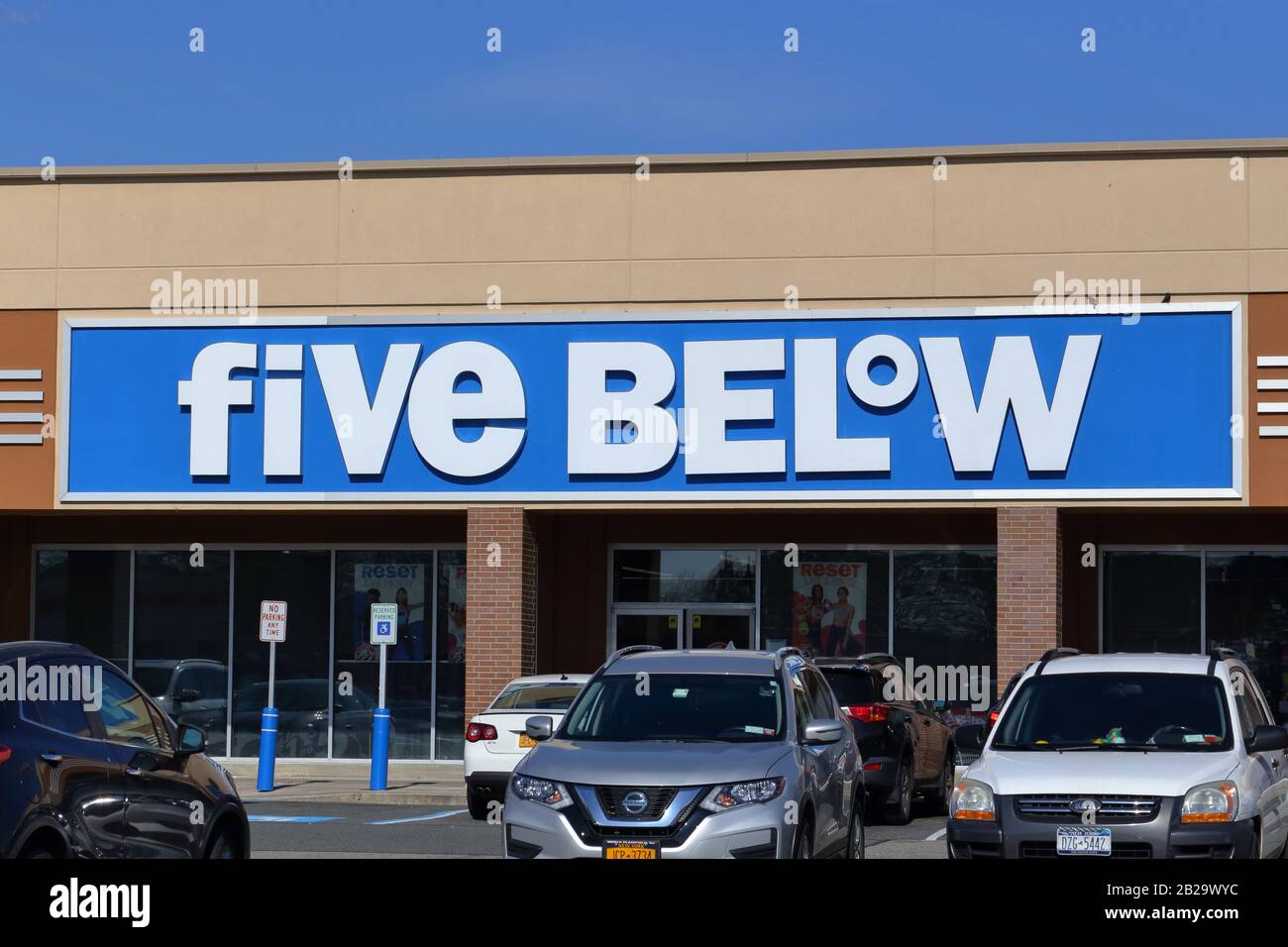 A Five Below sign at one of their discount variety stores at a shopping plaza in New York, NY. Stock Photo
