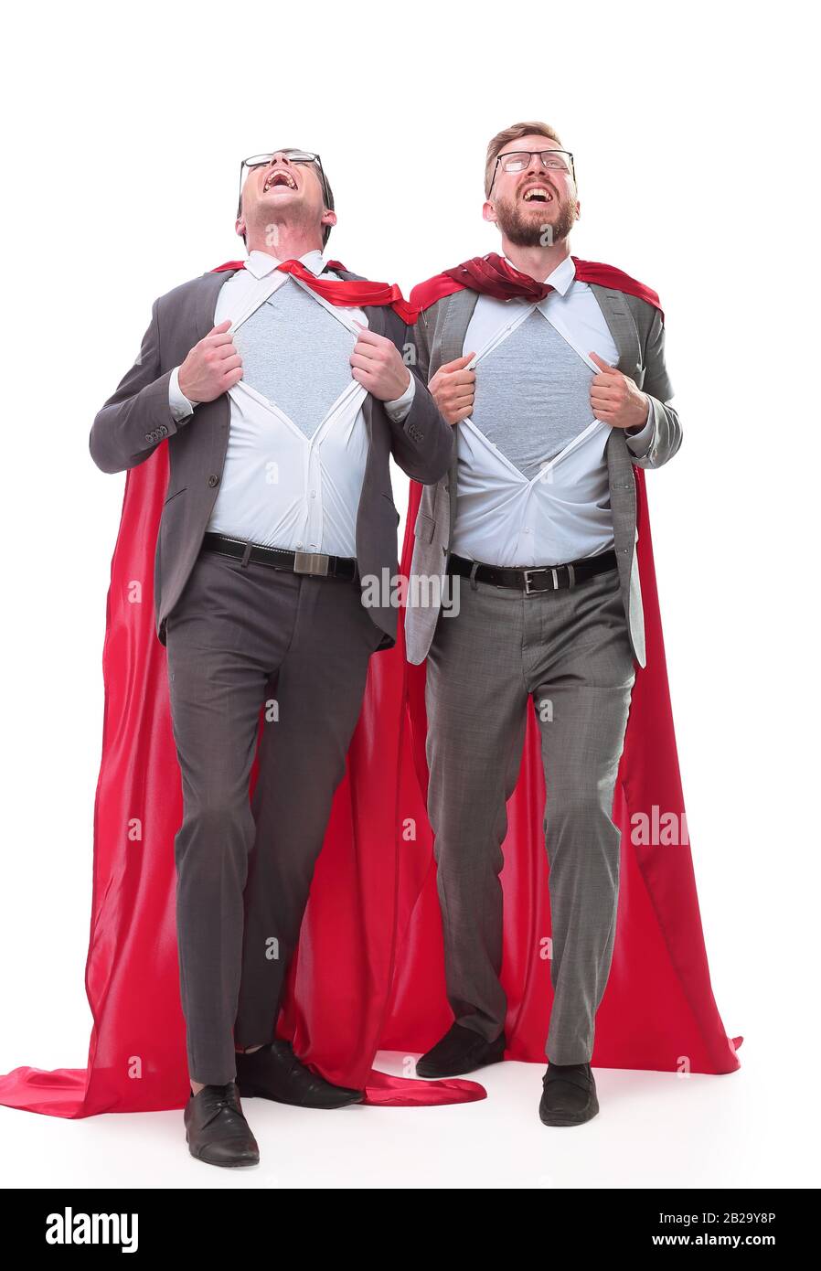 two business colleagues in red capes standing in Superman pose Stock ...