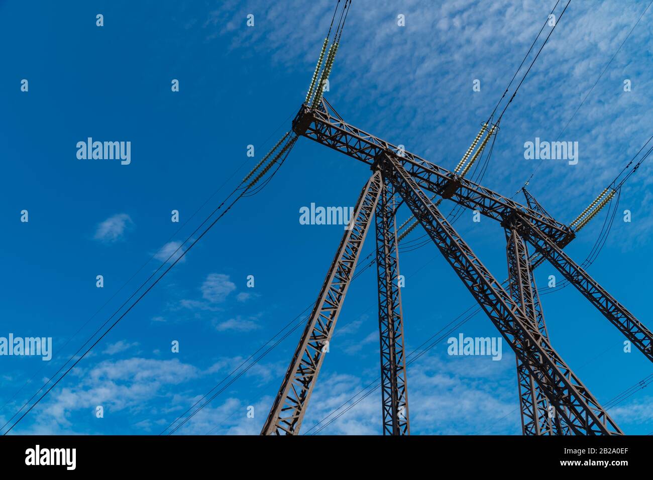 High-voltage power lines against a cloudy sky Stock Photo - Alamy
