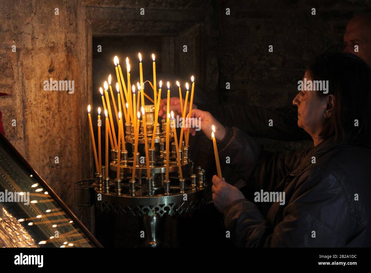 Lighting candles inside a Greek orthodox church, December 15 2019 Stock