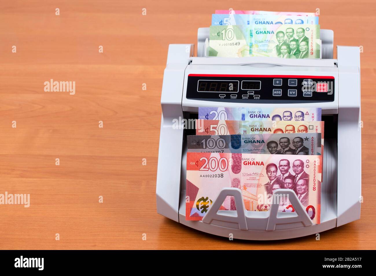 Money from Ghana in a counting machine Stock Photo Alamy
