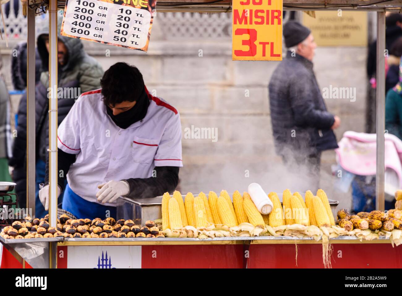 Street vendor selling roasted chestnuts and sweetcorn from a stall, Istanbul, Turkey. Stock Photo