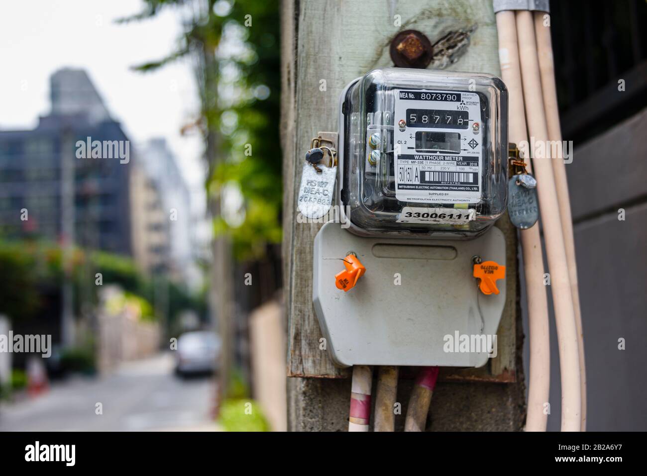 Electricity meter on an electricity pole in Thailand Stock Photo