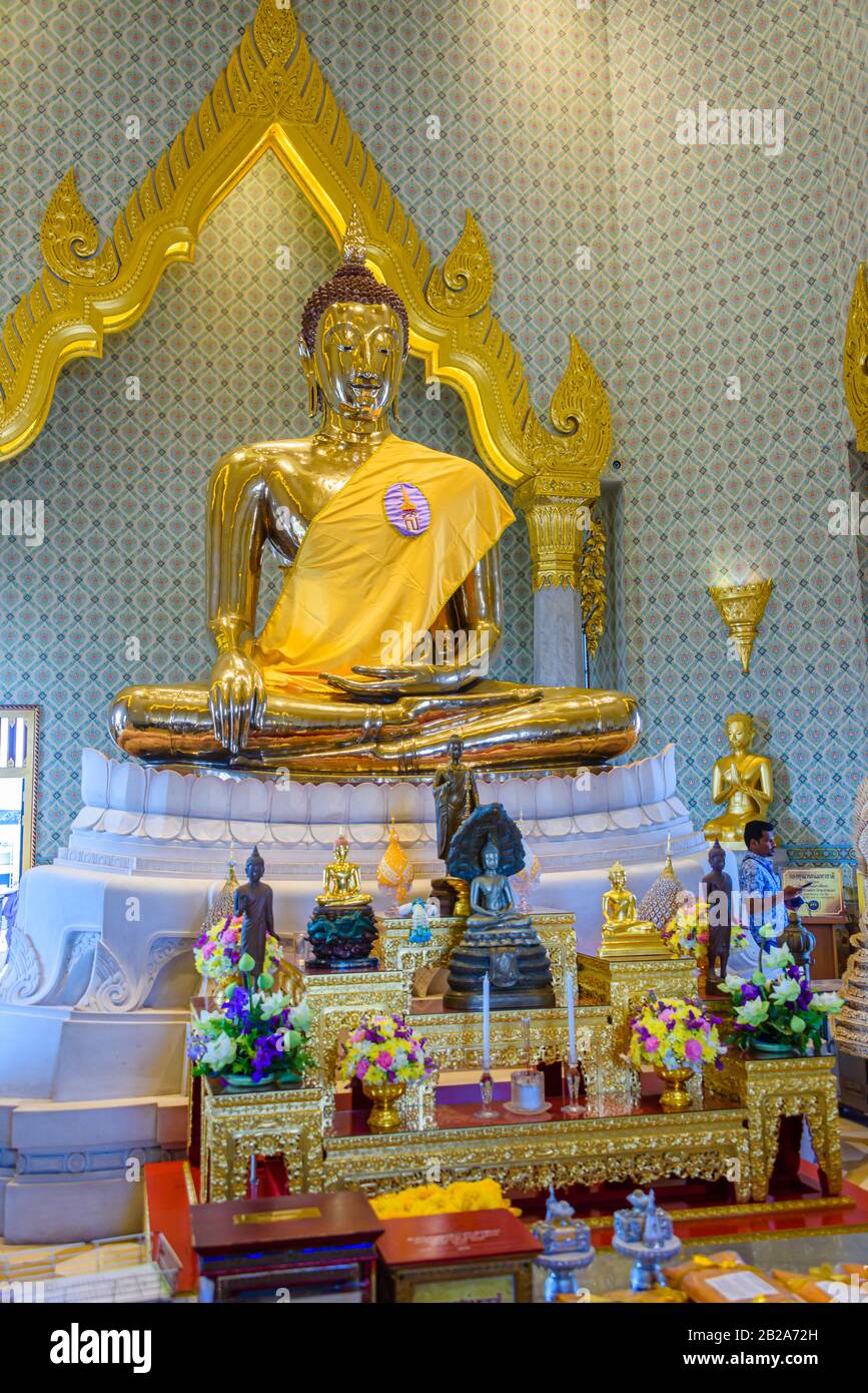Golden statue of Buddha with a saffron robe and shrine, Wat Songkhram, Bangkok, Thailand Stock Photo