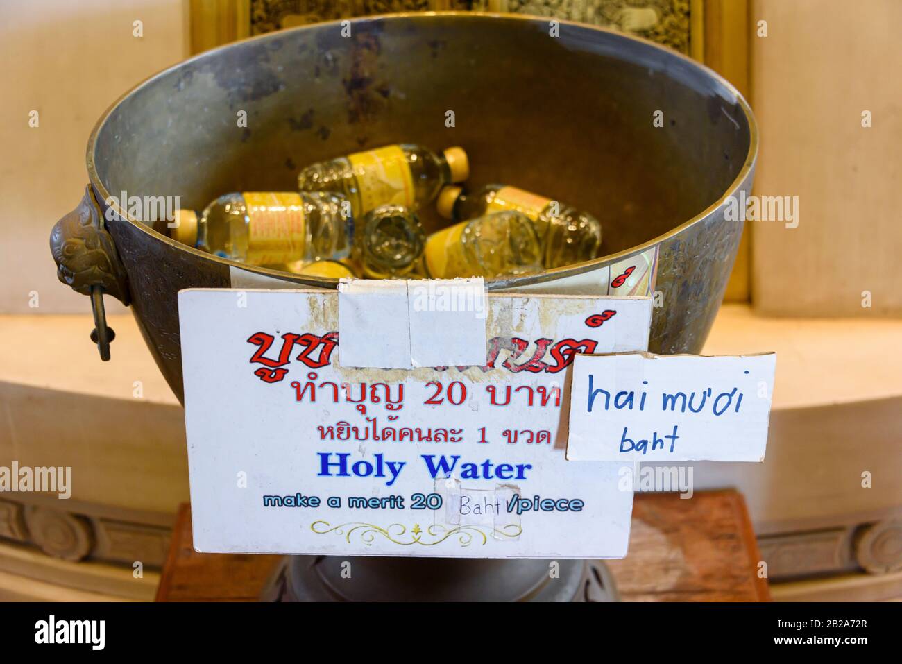 Bottles of 'holy water' for sale at a Buddhist temple for tourists and visitors, Bangkok, Thailand Stock Photo