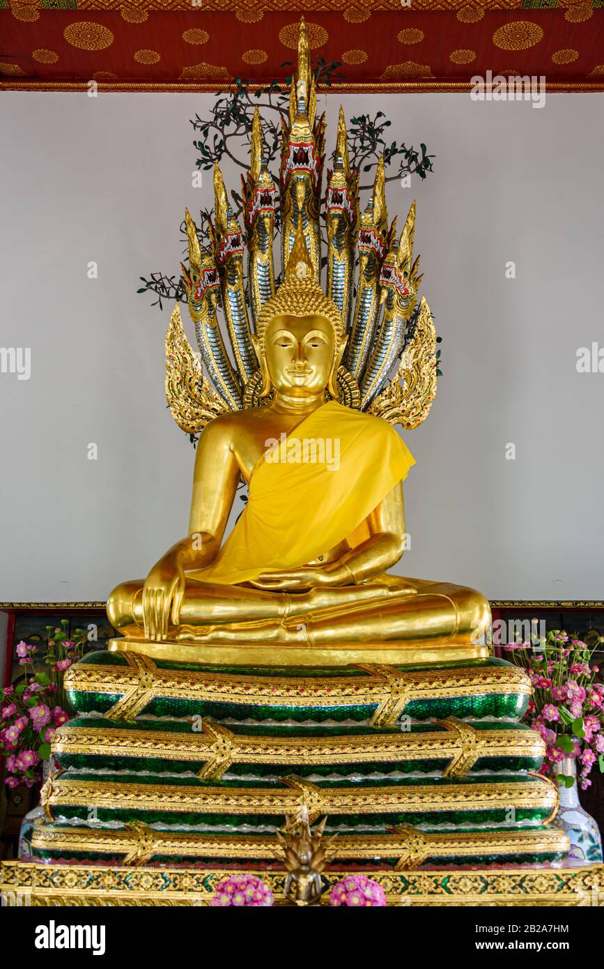 Golden Buddha Statue wearing a saffron robe, with a multi