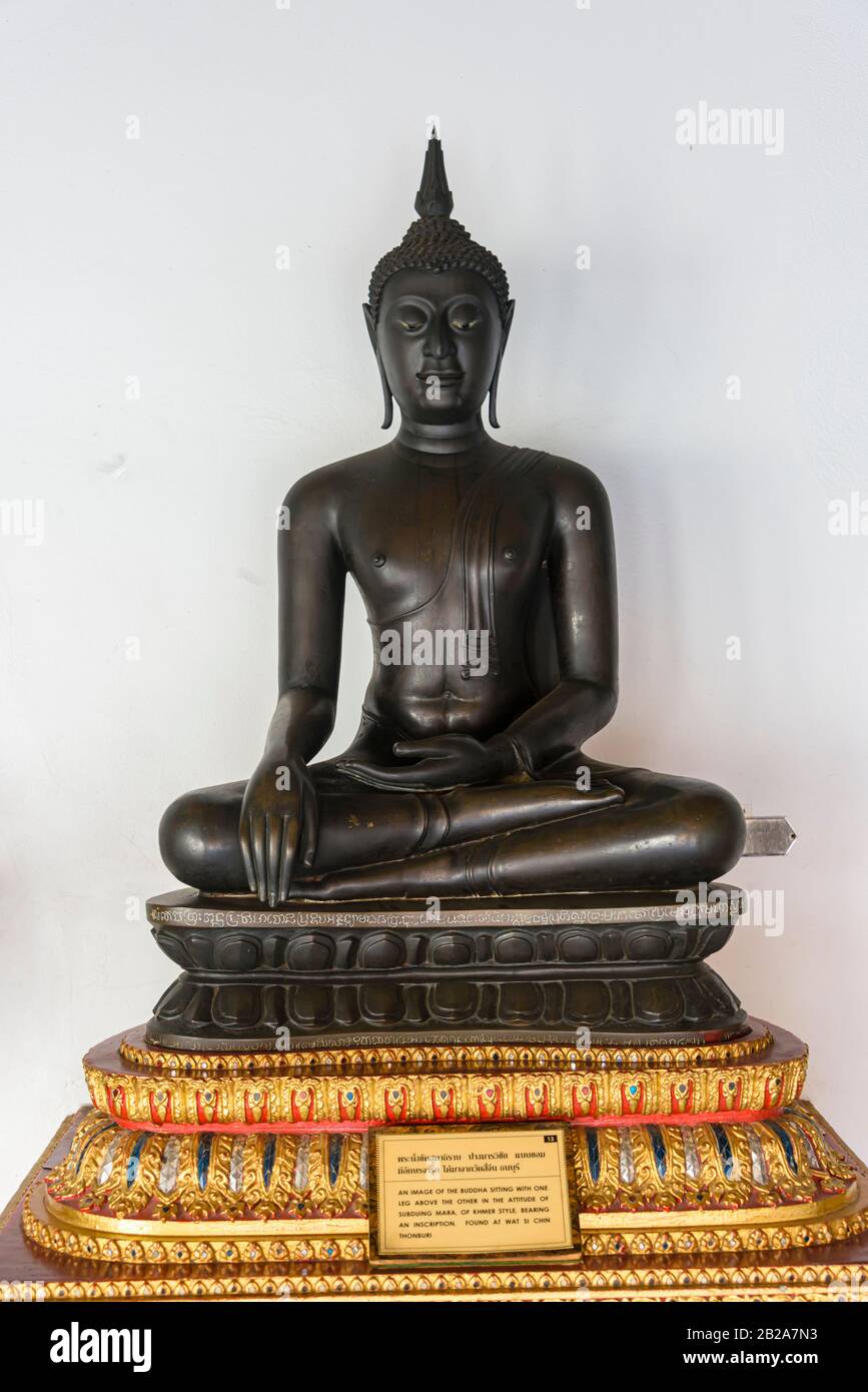 Image of Buddha sitting with one leg above the other in the attitude of subduing mara, Wat Benchamabophit (The Marble Temple), Bangkok, Thailand Stock Photo