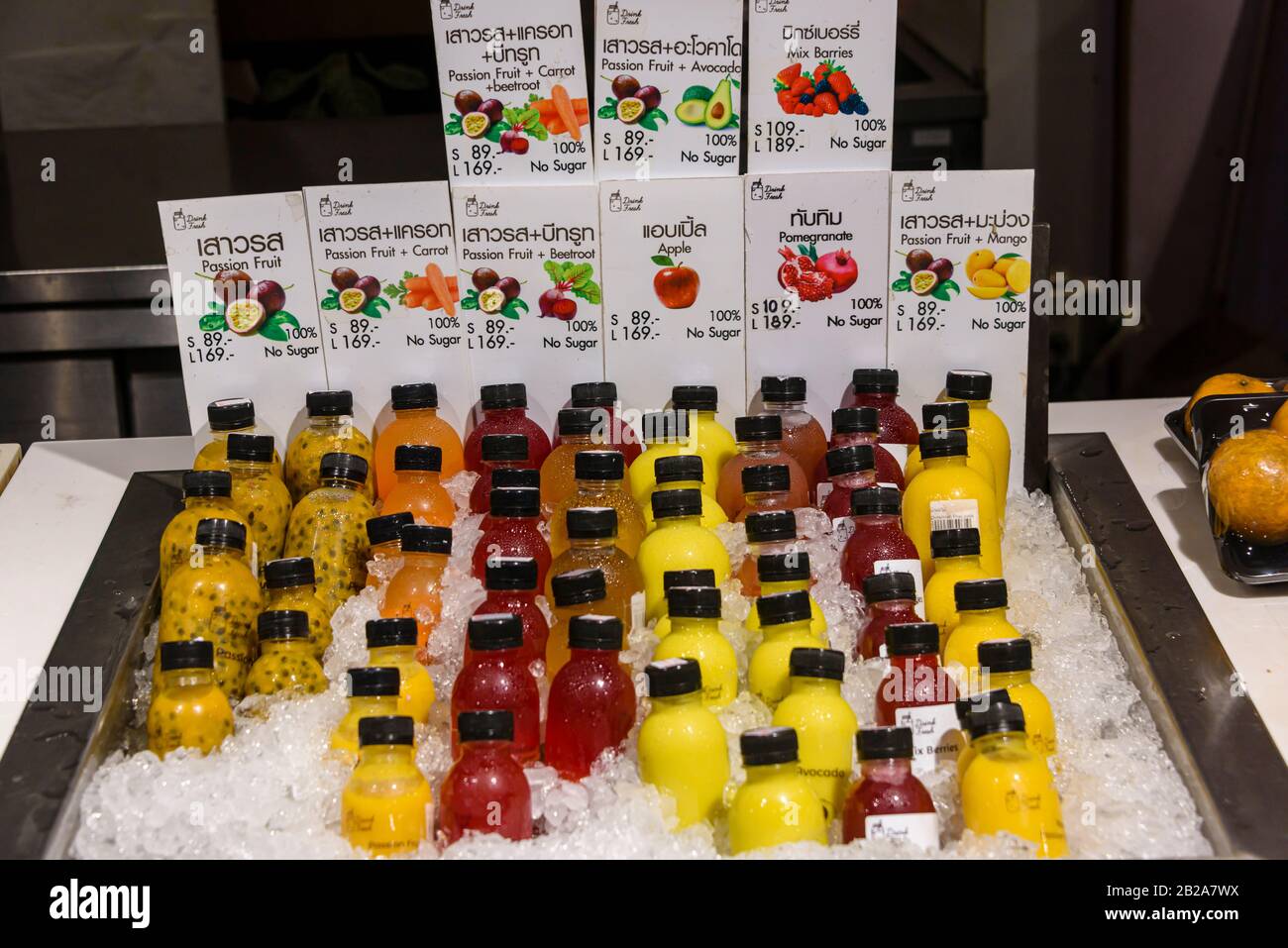 Selection of fruit and vegetable juices on ice in a supermarket, Bangkok, Thailand Stock Photo