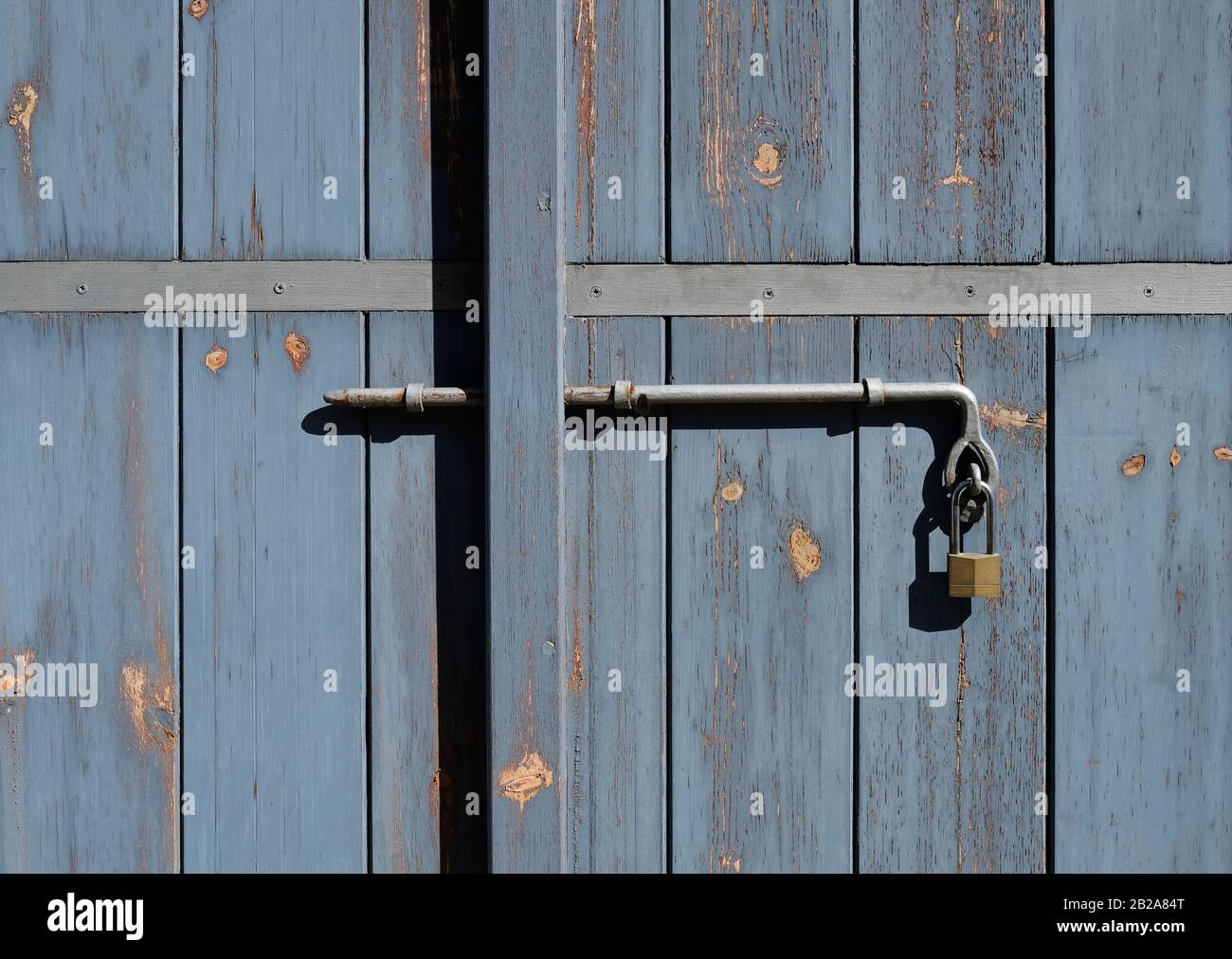 Metal lock on weathered wooden door Stock Photo - Alamy