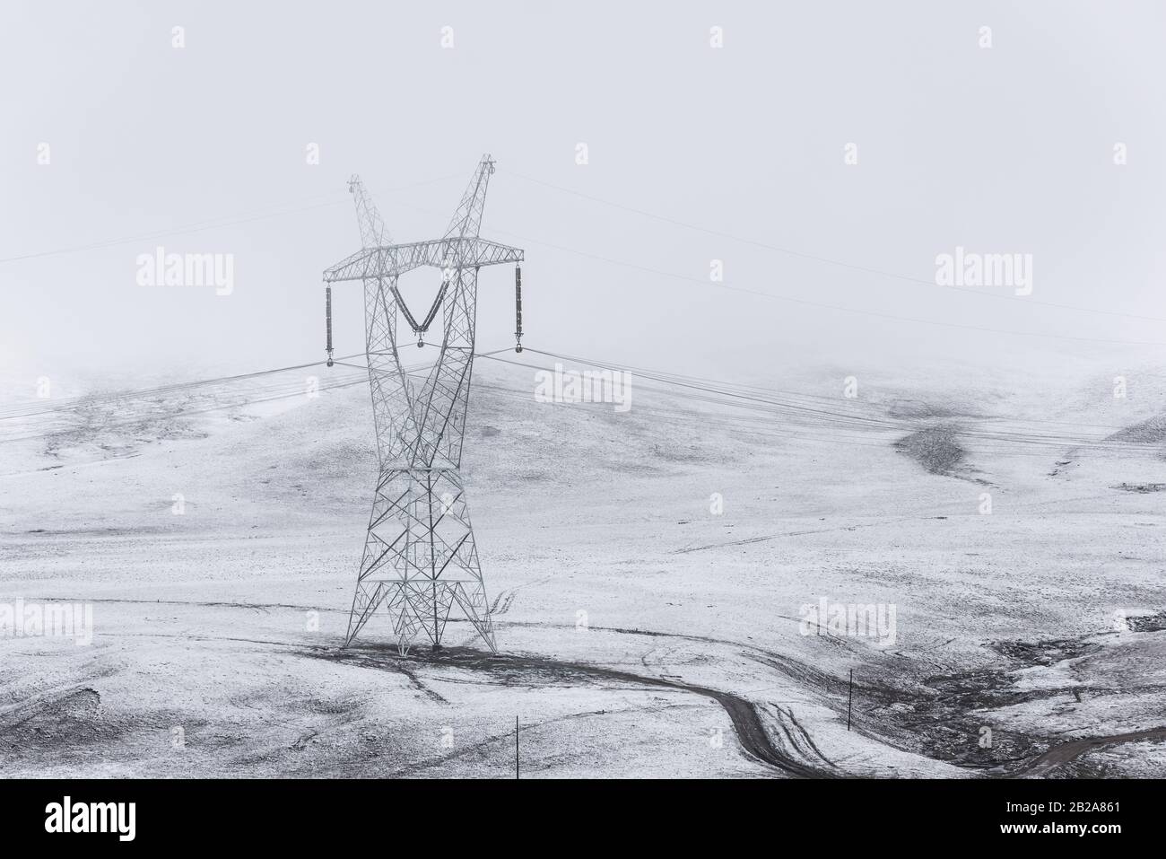 electricity pylon on a mountain which covered with snow Stock Photo - Alamy